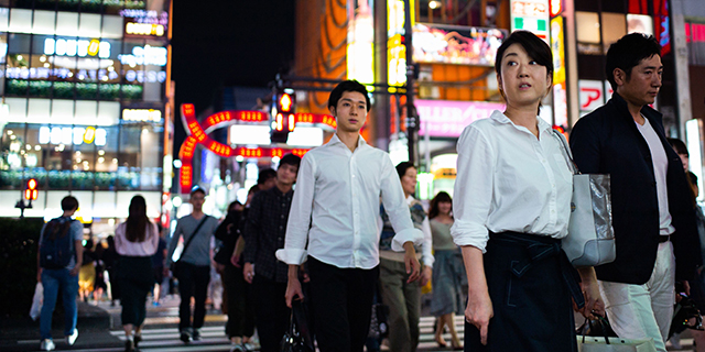 People walking in the streets of Shinjuku district of Tokyo. (Martin Bureau/AFP/Getty Images)